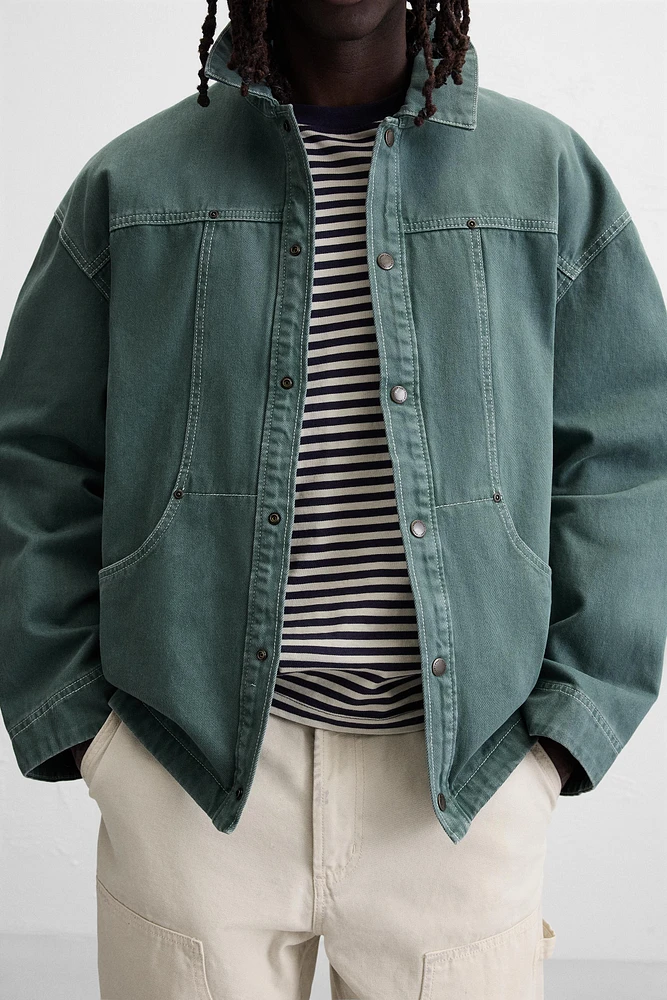 VESTE DÉLAVÉE SURPIQÛRES CONTRASTÉES