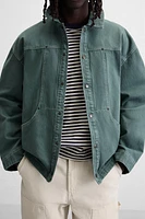 VESTE DÉLAVÉE SURPIQÛRES CONTRASTÉES