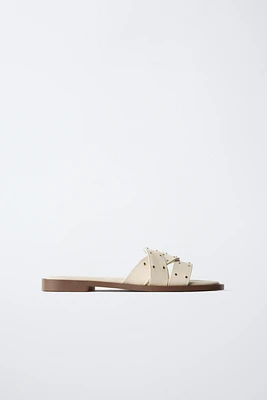 STUDDED CROSSOVER FLAT SANDALS