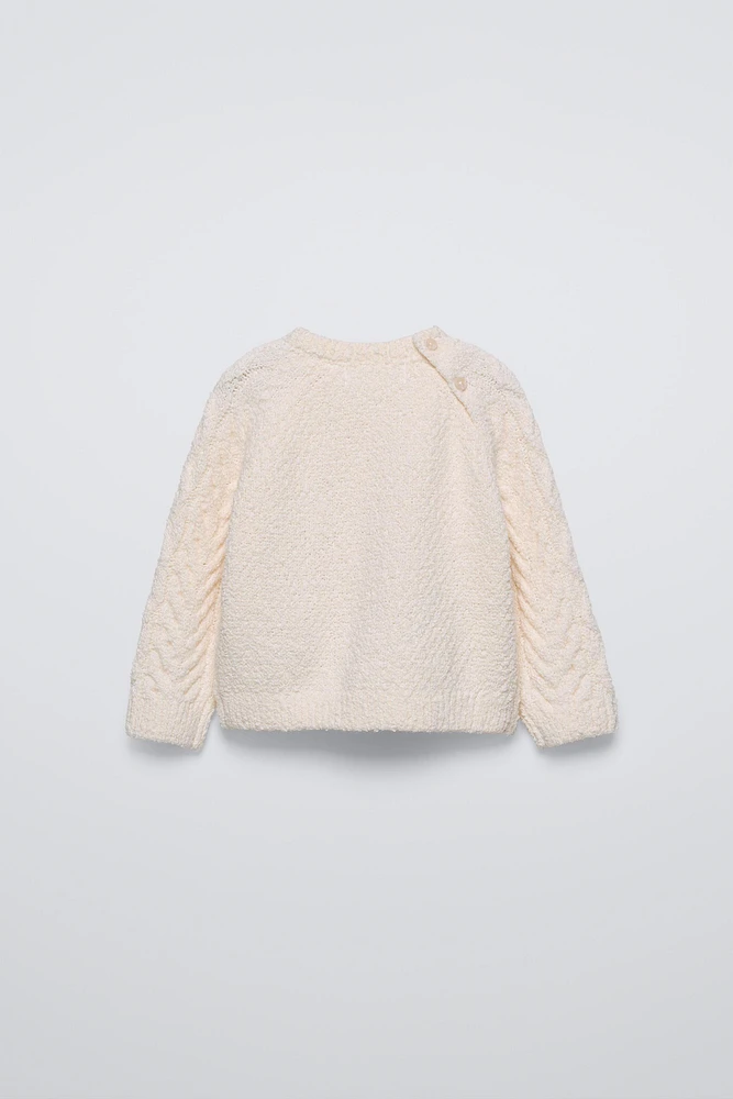 PULL EN MAILLE À TORSADES