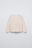 PULL EN MAILLE À TORSADES