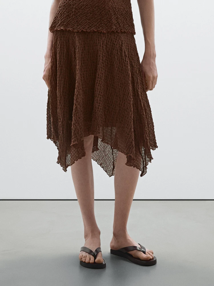 Flowing check skirt with asymmetric hem