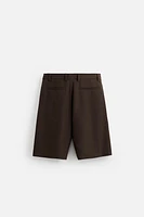 TEXTURED PLEATED SHORTS