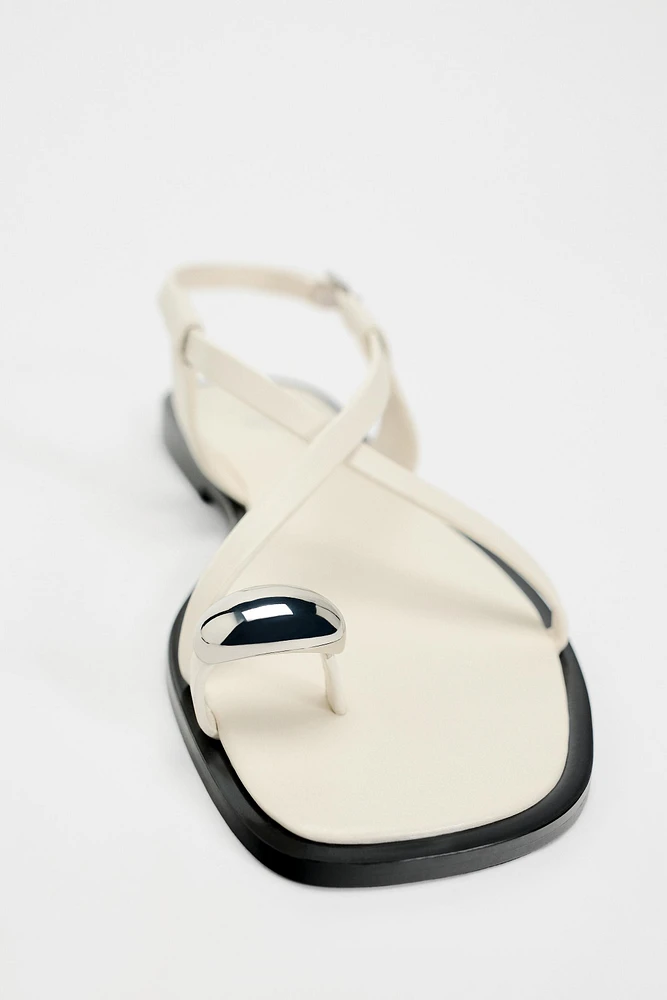 FLAT STRAPPY SANDALS WITH METAL ORNAMENT