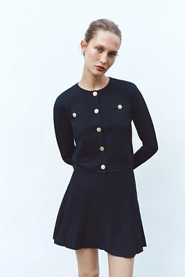 BOX PLEAT KNIT MINI SKIRT