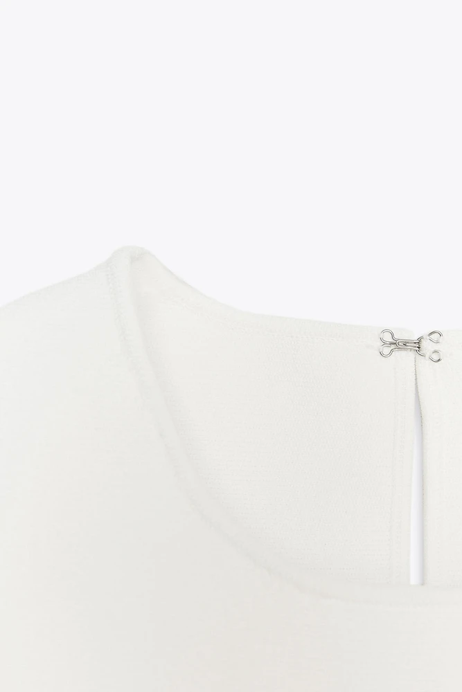 TIE-DETAIL PEPLUM KNIT TOP