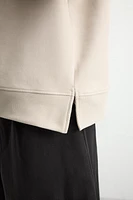 SWEAT TECHNIQUE À CAPUCHE
