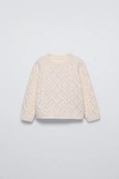 PULL EN MAILLE À TORSADES