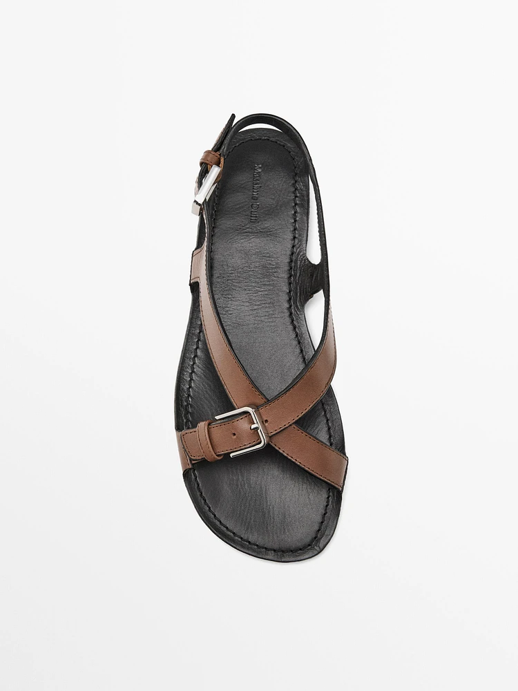 Flat leather sandals with buckles