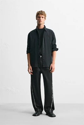 JEAN RELAXED FIT COUTURE EFFRANGÉE