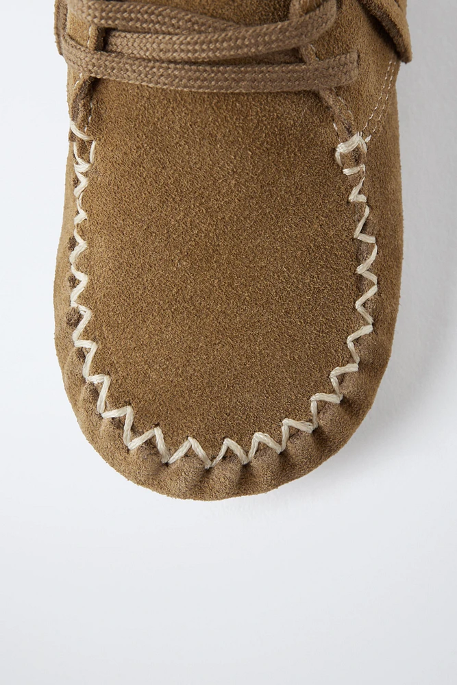 BOTTES EN CUIR À FRANGES