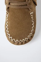 BOTTES EN CUIR À FRANGES
