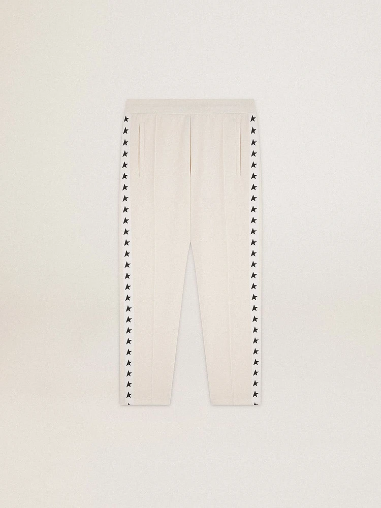 Men's white joggers with black stars on the sides