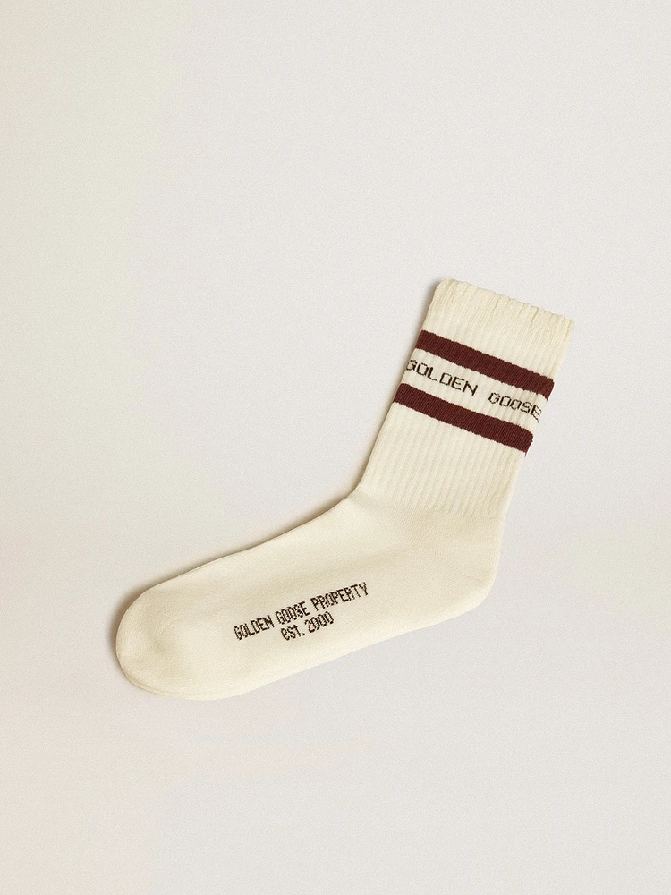 Worn-white socks with distressed details and brown stripes