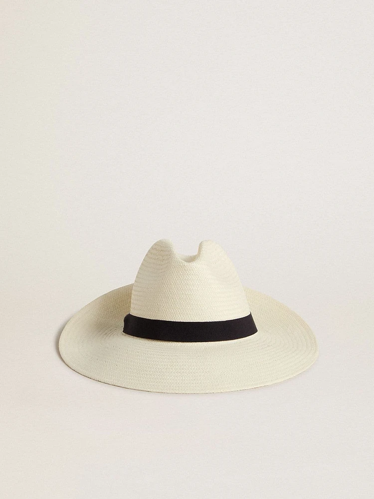 Golden fedora hat in white straw with black ribbon and marine print under the brim