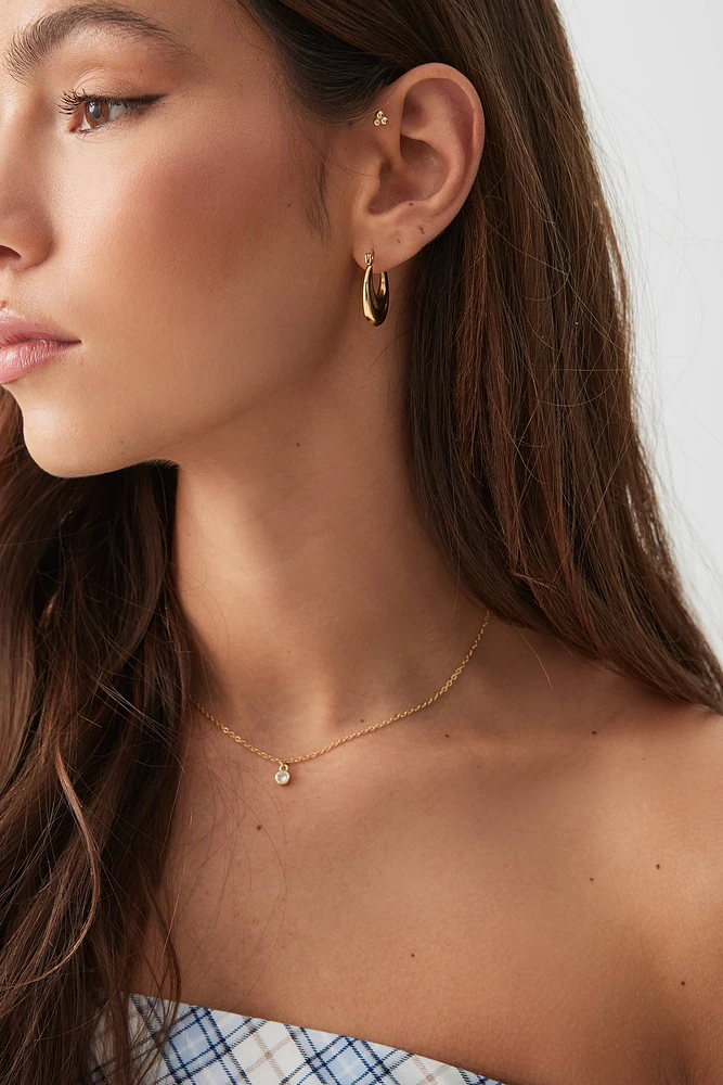 Ardene Stainless Steel Oval Hoop Earrings in Gold