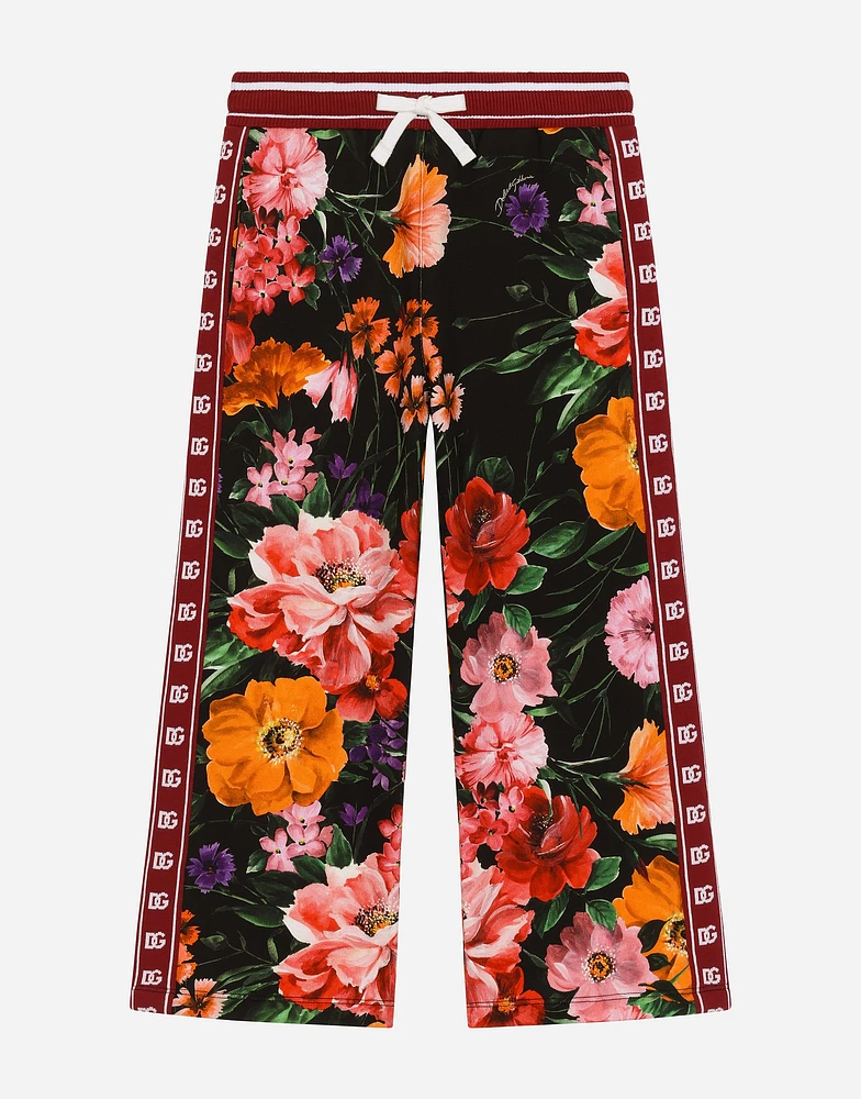Jersey jogging pants with floral print over a black background