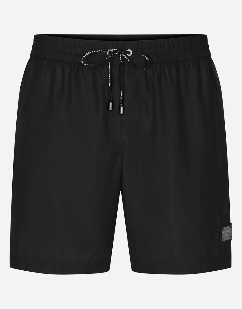 Mid-length swim trunks with branded plate
