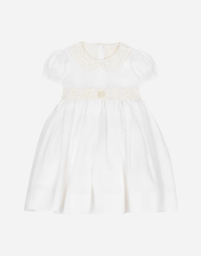 Empire-line muslin christening dress with short sleeves