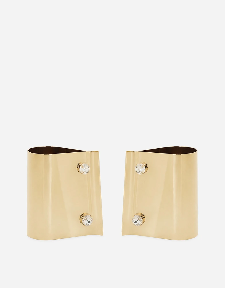 Rigid metal cuffs and rhinestone-detailed buttons