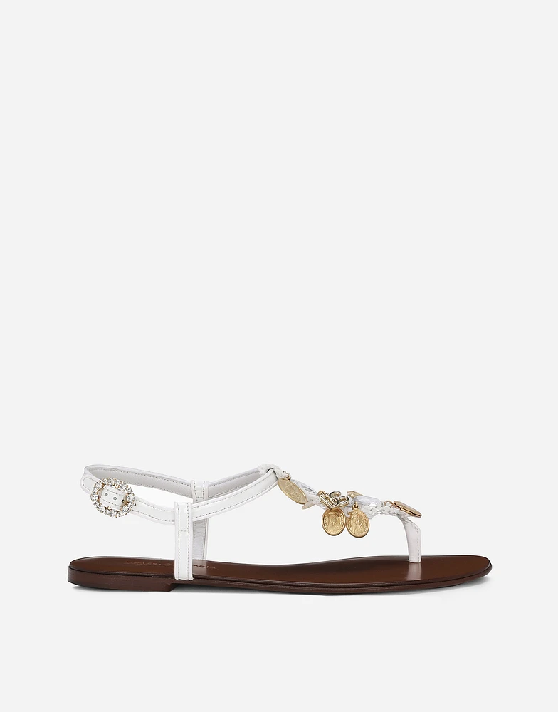Raffia thong sandals with embroidered votive medallions