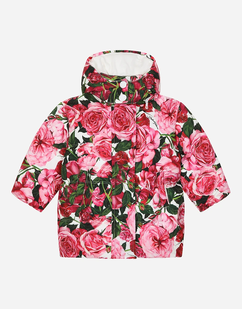 Short nylon down jacket with rose print over a white background
