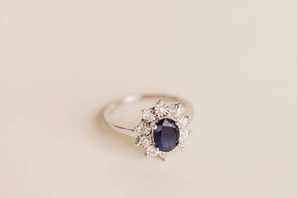 Oval Halo Ring with Blue Sapphire and .18 Carat TW of Diamonds in 10kt White Gold