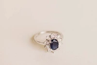 Oval Halo Ring with Blue Sapphire and .18 Carat TW of Diamonds in 10kt White Gold