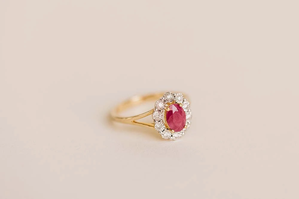 Oval Halo Ring with Ruby and .12 Carat TW of Diamonds in 10kt Yellow Gold