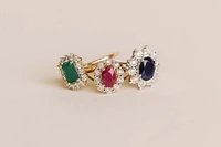 Oval Halo Ring with Ruby and .12 Carat TW of Diamonds in 10kt Yellow Gold
