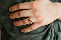 Ring with Garnet and .10 Carat TW of Diamonds in 10kt White and Yellow Gold