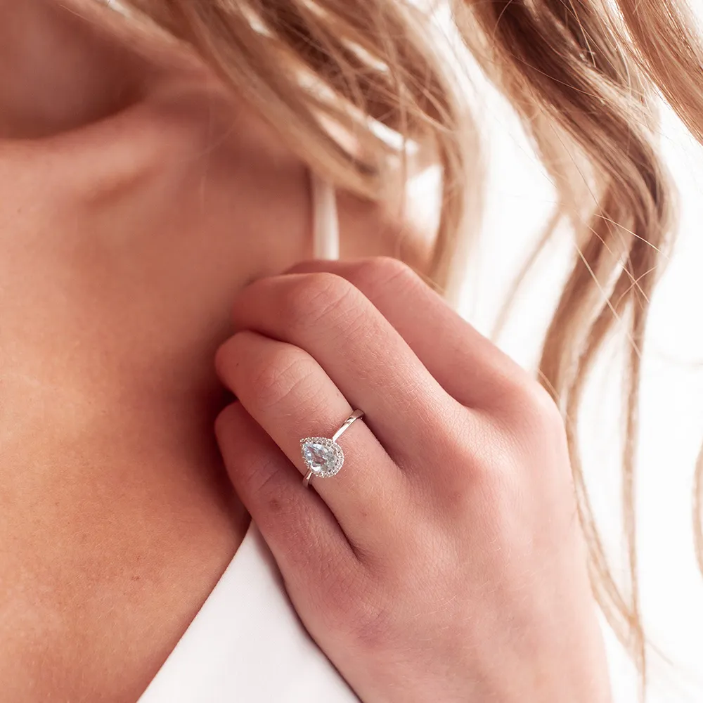 Halo Ring with Aquamarine and .09 Carat TW of Diamonds in 10kt White Gold