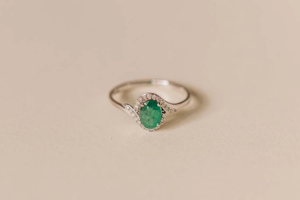 Halo Ring with .10 Carat TW of Diamonds and 7x5MM Oval Emerald in 10kt White Gold