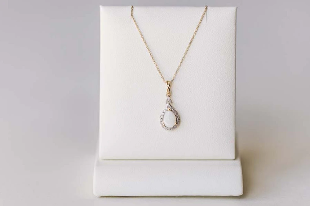 Halo Pendant with .13 Carat TW of Diamonds and 7x5MM Pear Shape Opal in 10kt Yellow Gold with Chain
