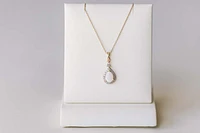 Halo Pendant with .13 Carat TW of Diamonds and 7x5MM Pear Shape Opal in 10kt Yellow Gold with Chain