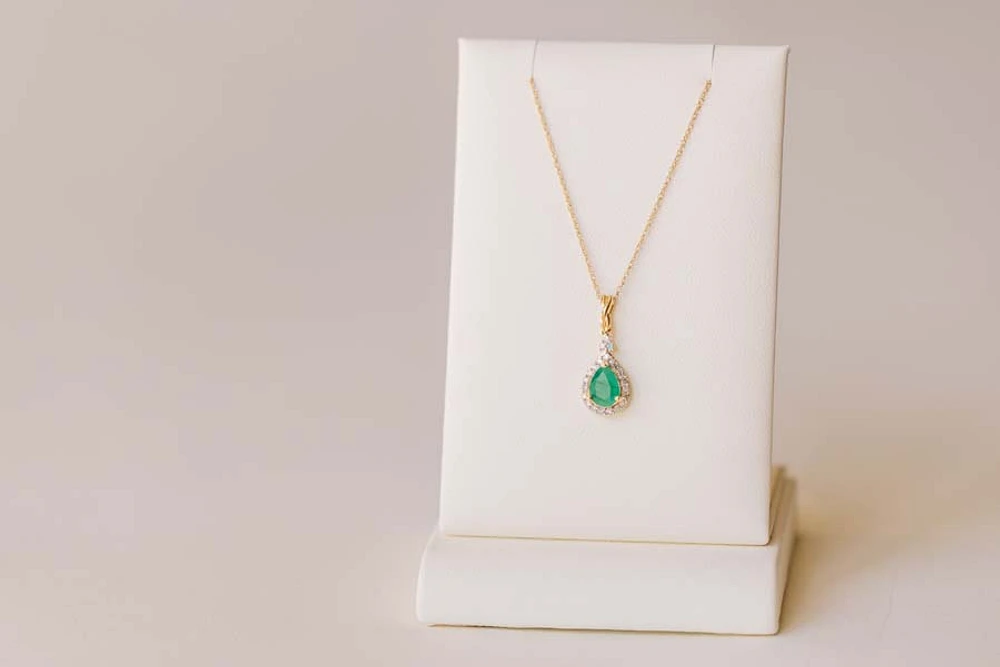 Halo Pendant with .13 Carat TW of Diamonds and 7x5MM Pear Shape Emerald in 10kt Yellow Gold with Chain