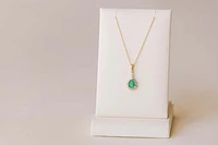 Halo Pendant with .13 Carat TW of Diamonds and 7x5MM Pear Shape Emerald in 10kt Yellow Gold with Chain